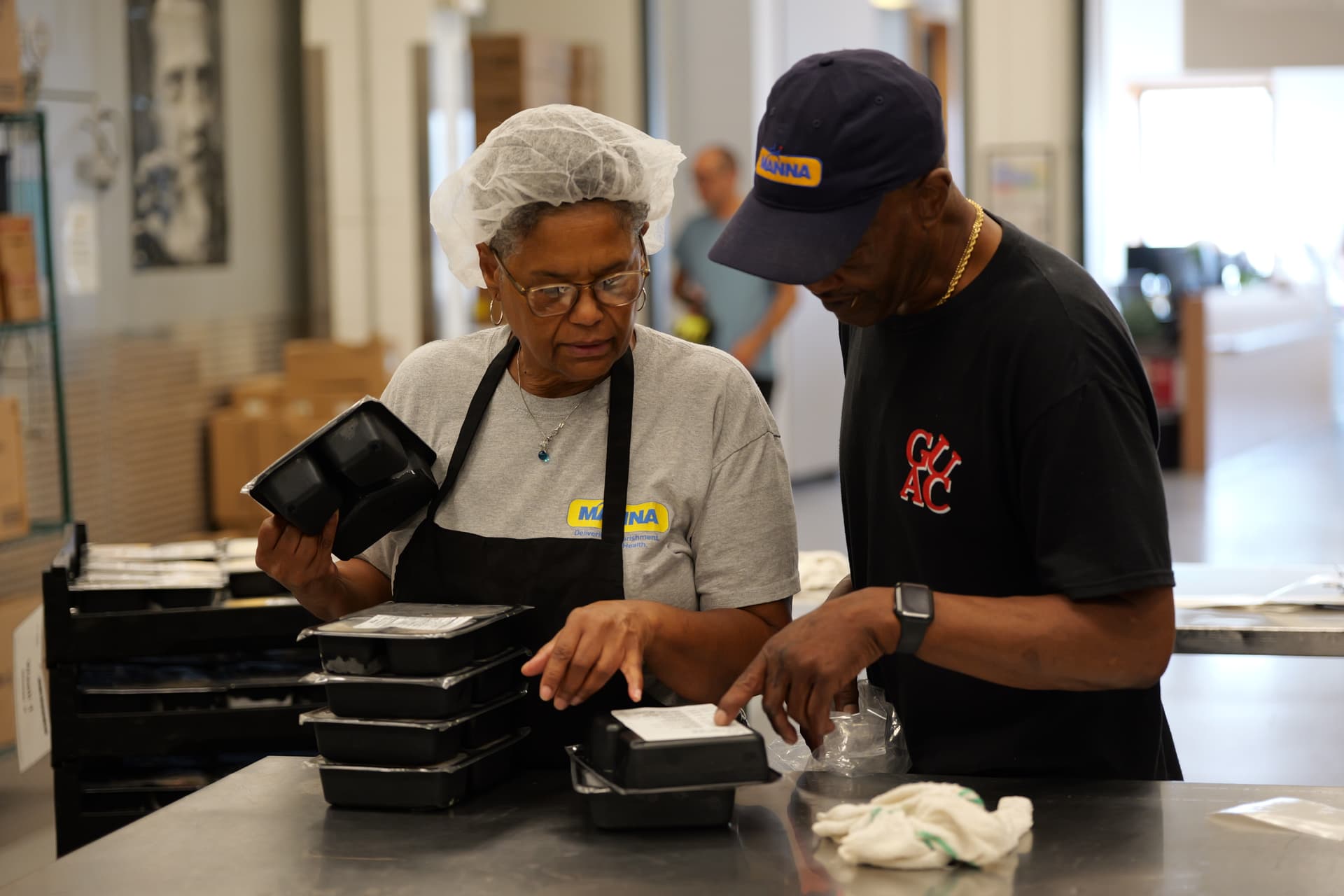 Davita and Craig packing and double checking Client Choice meals.