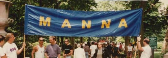 A blue banner with the MANNA in yellow letters during an event in the 90s.